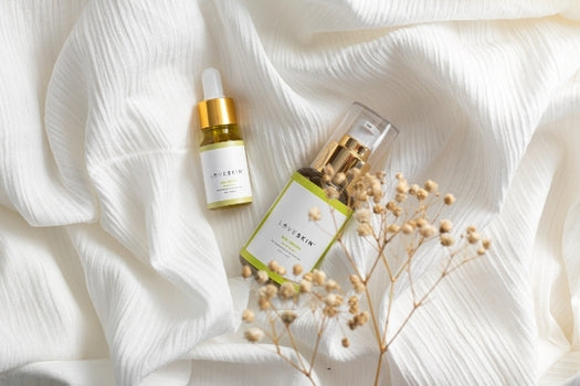 kiri aroha acne and oily skin serum on white cloth background with flowers