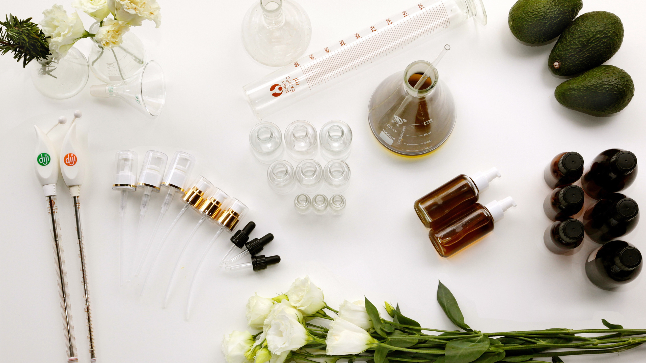 ottles and measuring tools arranged on a table for making skincare products