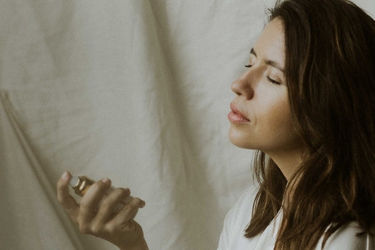 woman spraying kakara facial toning mist on face