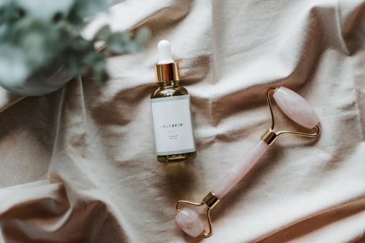 Waiwai skin serum and rose quartz facial roller flatlay