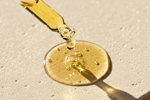 dropping skincare oil onto concrete texture