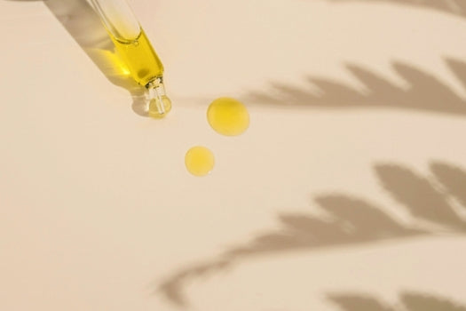 Oil based serum dropper on plain background
