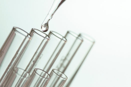 dropping clear liquid into clear vials