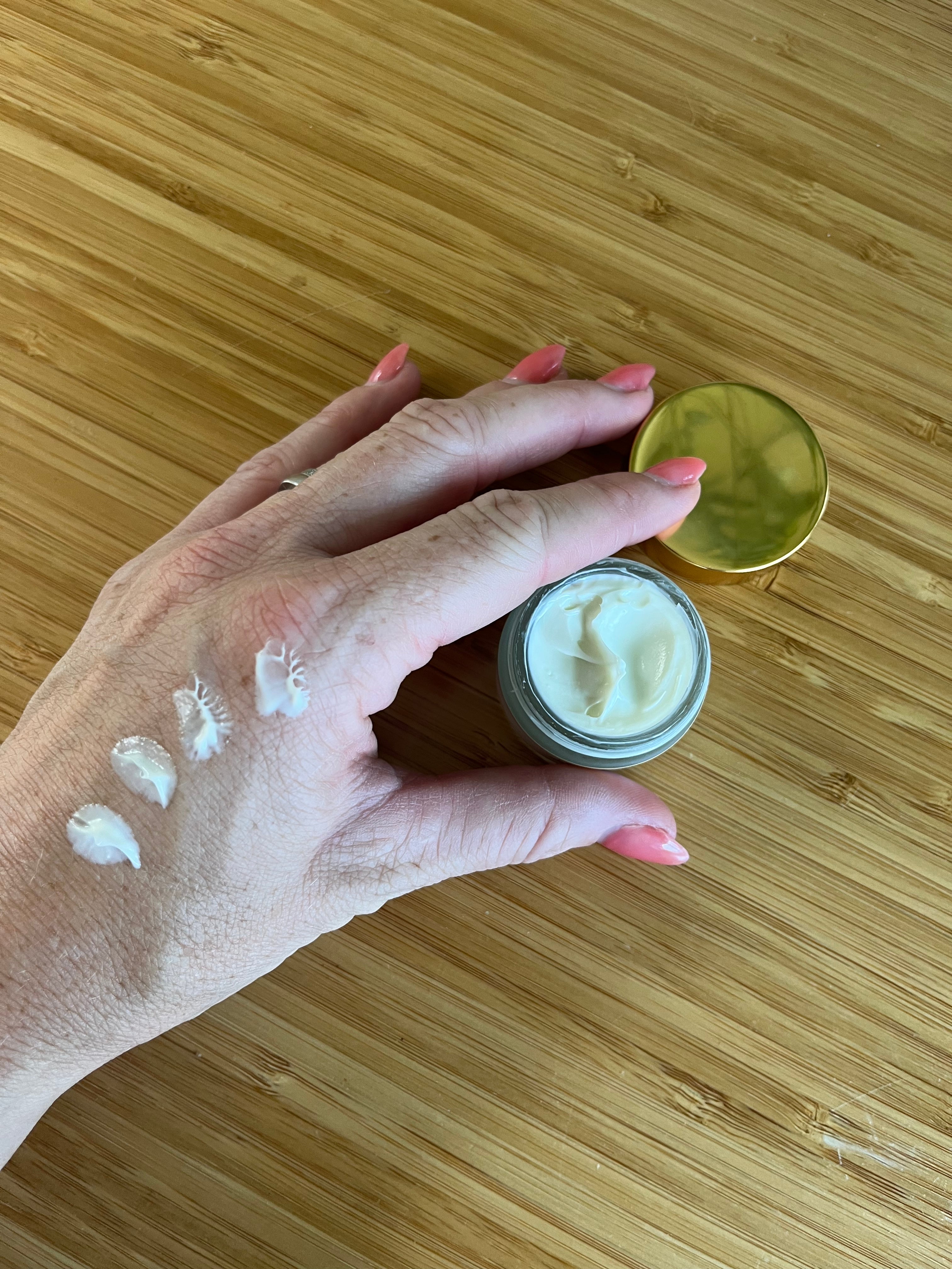Hand with LOVESKIN's smoothing eye butter applied