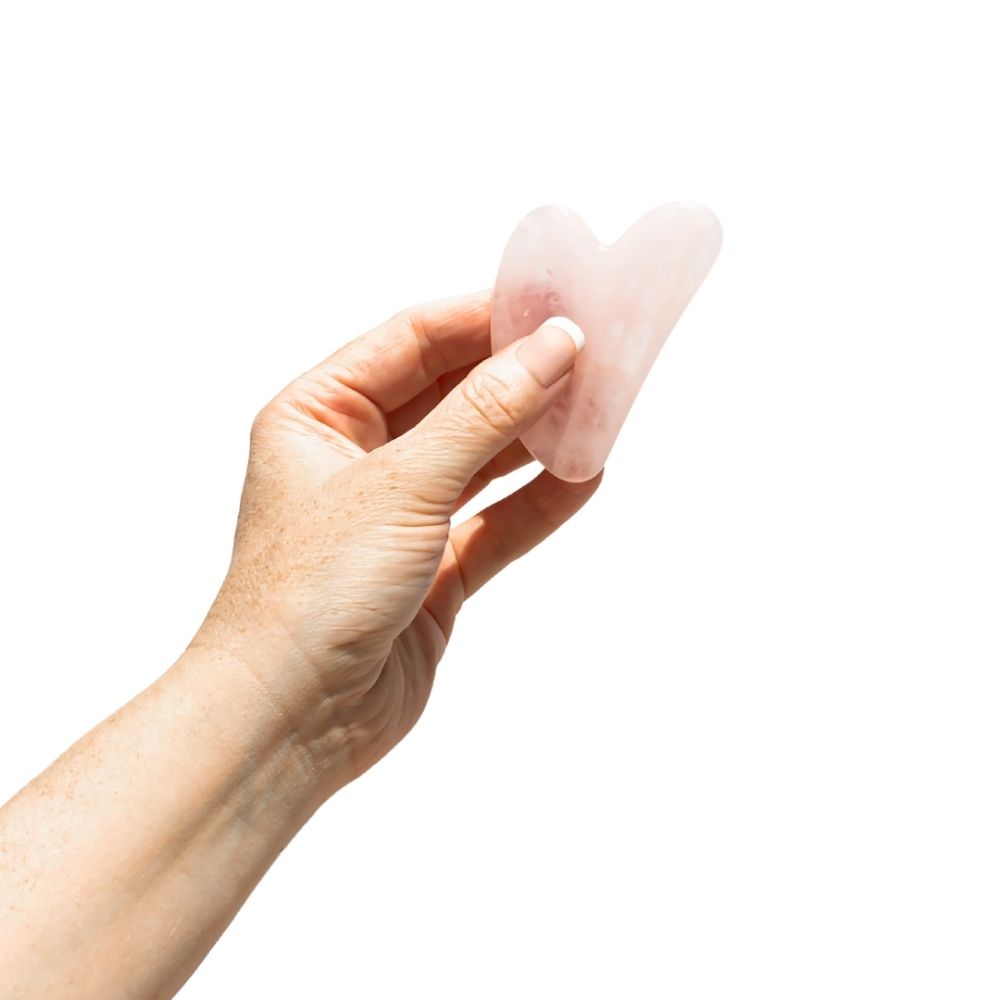 Hand holding Rose Resin Guasha Facial Massager.