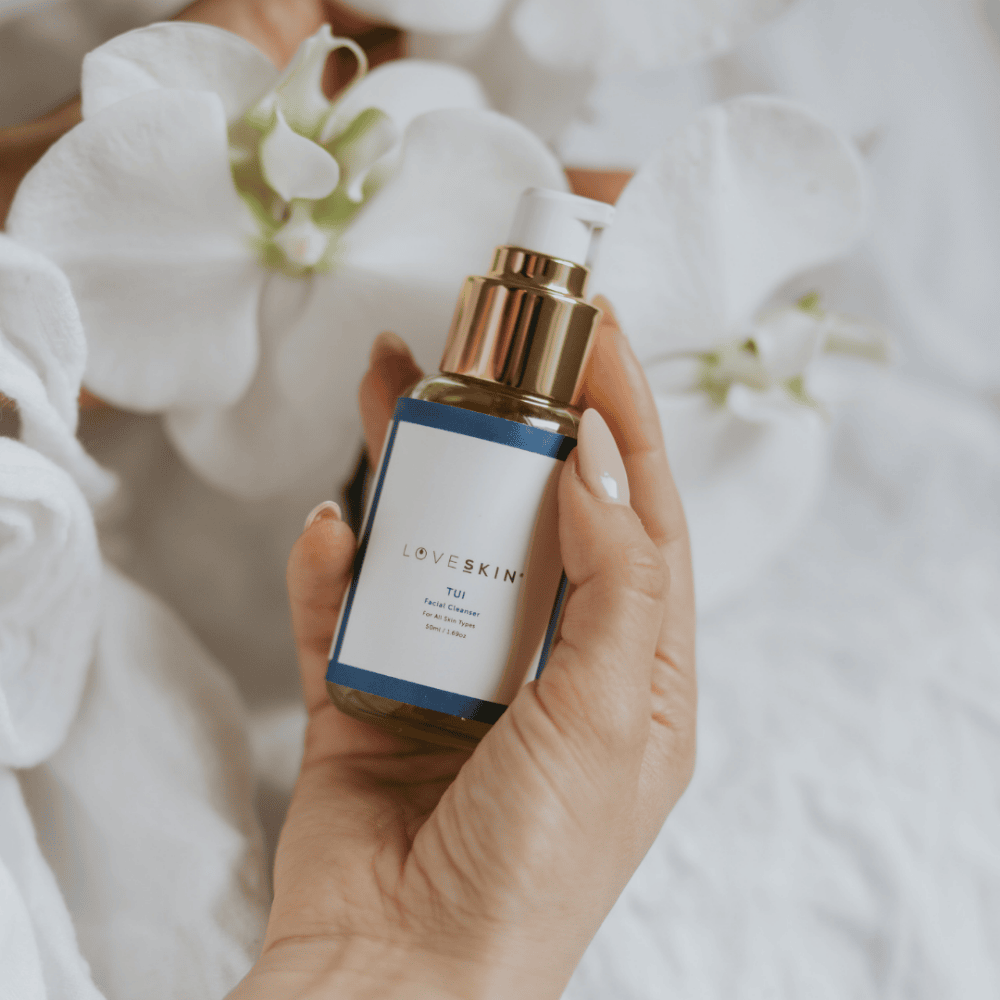 Hand holding a bottle of 50ml LoveSkin's Tui Facial Cleanser