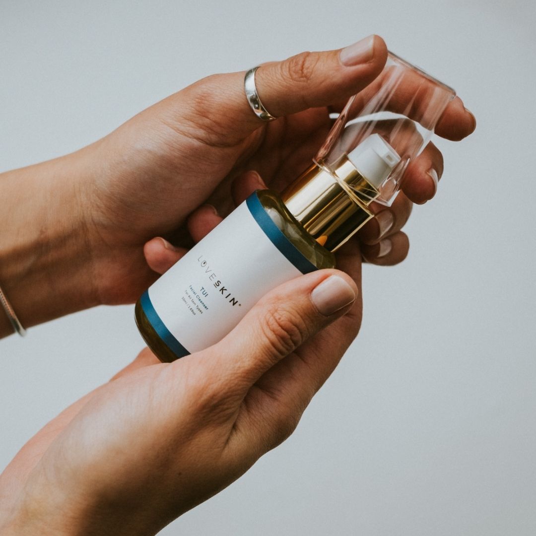 Hands holding the tui facial cleanser