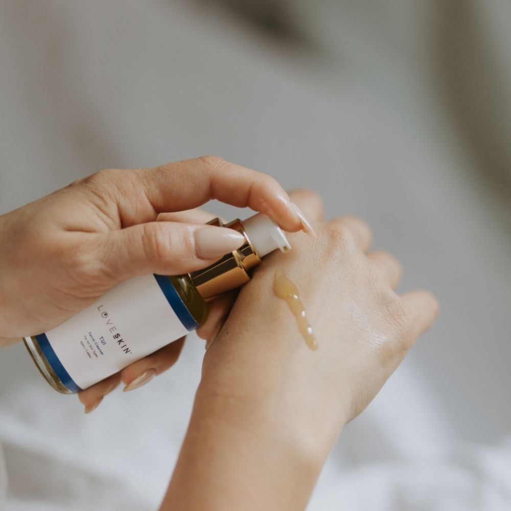 Close-up of skin applying LoveSkin Tui cleansing oil onto hand