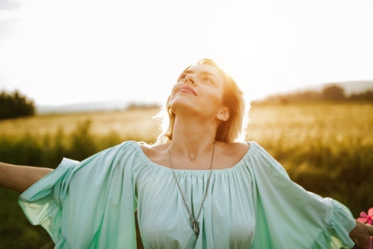 woman frolicking in field after healing skin
