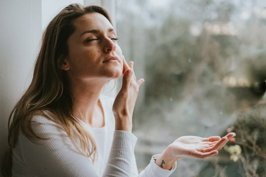 Woman applying natural oil based facial serum