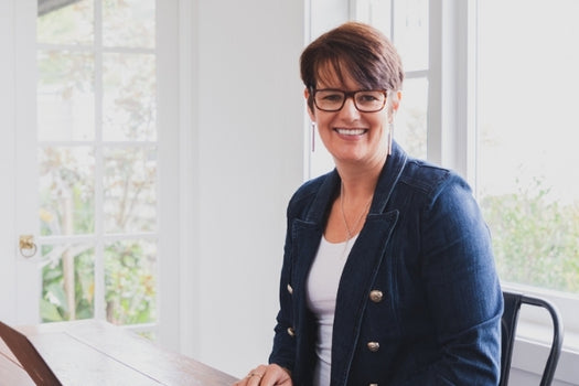 LOVESKIN NZ founder sitting and smiling at camera