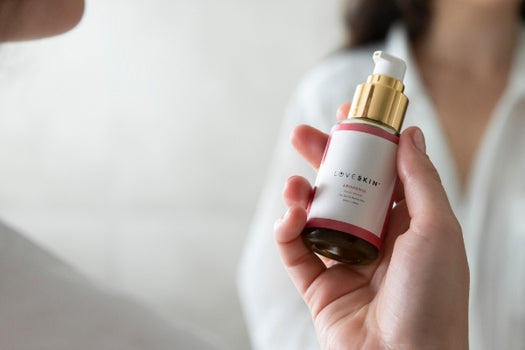 hand holding bottle of arohanui facial serum in front of another person