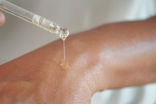 applying skin oil to eczema patch on wrist