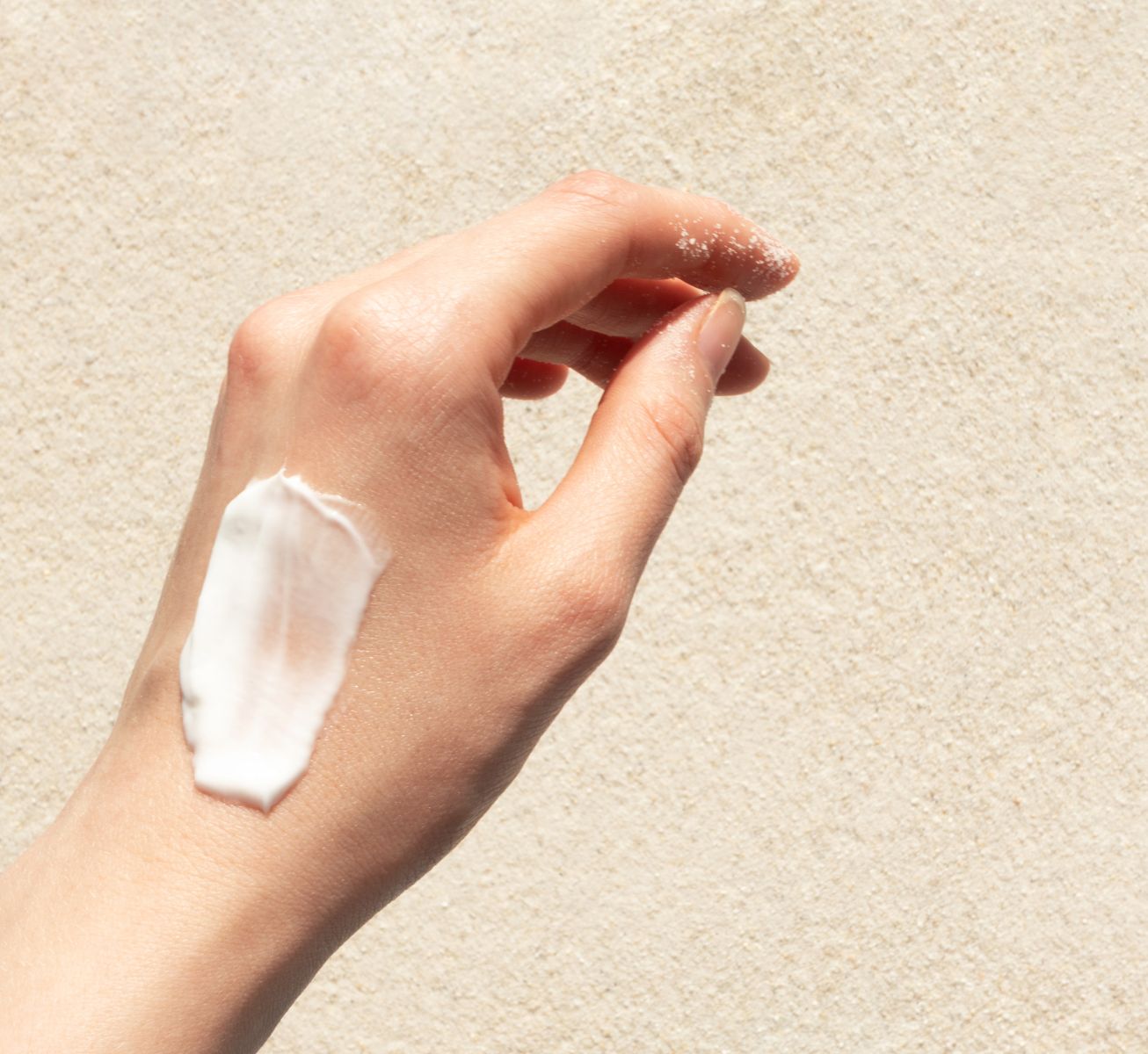 A hand with coconut and mango hand lotion, showing a non-greasy and hydrating hand cream for soft skin.
