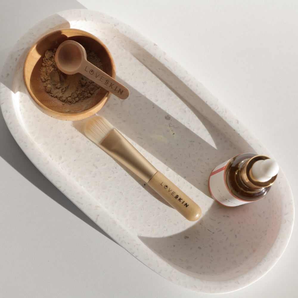 Hana Glacial Clay Mask set with applicator brush, wooden mixing bowl, and NZ-made facial serum for hydrated skin